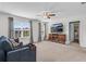 Spacious living room features windows with natural light, a ceiling fan and a comfortable sofa at 704 Woodbridge Dr, Woodstock, GA 30188