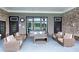 Cozy outdoor patio with comfortable seating and view of pool with a brick accent wall at 704 Woodbridge Dr, Woodstock, GA 30188