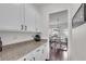 Convenient pantry with granite counters and storage cabinets at 704 Woodbridge Dr, Woodstock, GA 30188