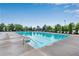 Large community swimming pool surrounded by lounge chairs and mature landscaping at 704 Woodbridge Dr, Woodstock, GA 30188