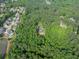 Aerial view of a home nestled among lush, green trees, in a serene, residential area at 814 Clarke Trl, Dacula, GA 30019