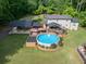Aerial view of the home highlighting the pool area, backyard, and surrounding lush greenery at 814 Clarke Trl, Dacula, GA 30019