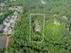 Aerial view of the property, a 2.83 acre lot with a home nestled among lush, green trees at 814 Clarke Trl, Dacula, GA 30019