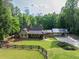 Spacious property showcasing well-maintained lawn, fence line, home, and covered parking area at 814 Clarke Trl, Dacula, GA 30019
