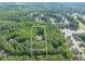 Aerial view of the property, a 2.83 acre lot with a home nestled among lush, green trees at 814 Clarke Trl, Dacula, GA 30019