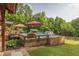 Backyard pool with umbrellas, landscaping, and various areas for entertaining on a well-kept lawn at 814 Clarke Trl, Dacula, GA 30019