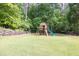 Backyard featuring a wooden playset including a slide, a swing, and a clubhouse at 814 Clarke Trl, Dacula, GA 30019