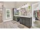 Bathroom featuring double vanity, stone countertops, sleek hardware, and a tiled shower at 814 Clarke Trl, Dacula, GA 30019