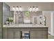 Bright bathroom features double vanity, stone countertops, sleek hardware and a tiled shower at 814 Clarke Trl, Dacula, GA 30019