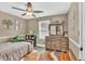 Charming bedroom with a twin bed, wooden dresser with mirror, and light-colored walls creating a serene atmosphere at 814 Clarke Trl, Dacula, GA 30019