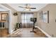 Bonus room filled with natural light, wood floors, and a Peloton bike for exercise at 814 Clarke Trl, Dacula, GA 30019