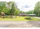Charming home exterior with a covered porch, well-manicured lawn, and tree-lined backdrop at 814 Clarke Trl, Dacula, GA 30019