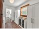 Hallway with wood floors, a decorative light fixture and built-in storage units at 814 Clarke Trl, Dacula, GA 30019