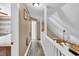 Upstairs hallway featuring wood-look floors, white railing, and neutral-colored walls, creating a clean and modern transition at 814 Clarke Trl, Dacula, GA 30019