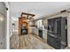 Charming kitchen boasting a brick feature, stainless steel appliances, and wood-look floors at 814 Clarke Trl, Dacula, GA 30019