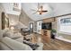 Comfortable living room featuring wood floors, a ceiling fan, and bright natural light at 814 Clarke Trl, Dacula, GA 30019