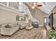 Inviting living room with vaulted ceilings, wood floors, and a cozy seating area at 814 Clarke Trl, Dacula, GA 30019