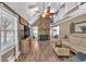 Spacious living room with a stone fireplace, wood floors, and vaulted ceilings at 814 Clarke Trl, Dacula, GA 30019