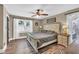 Serene bedroom with wood floors, a large window, and a decorative ceiling fan at 814 Clarke Trl, Dacula, GA 30019