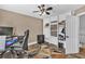 Functional office space with built-in shelving displaying collectibles, next to a computer desk with an ergonomic chair at 814 Clarke Trl, Dacula, GA 30019