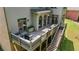 Aerial view of back deck with furniture, fire pit, and stairs leading to backyard and upper level at 1029 Laurel Grove Cts, Suwanee, GA 30024