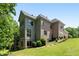 Back exterior of home features a multi-level deck, a mix of siding and brick, and mature landscaping at 1029 Laurel Grove Cts, Suwanee, GA 30024
