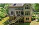 Large backyard featuring a spacious deck and a staircase leading to the ground level at 1029 Laurel Grove Cts, Suwanee, GA 30024
