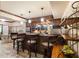 Elegant home bar with wood finishes, pendant lighting, and bar stool seating at 1029 Laurel Grove Cts, Suwanee, GA 30024