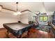 Basement featuring hardwood flooring, a pool table, and a comfortable seating area at 1029 Laurel Grove Cts, Suwanee, GA 30024
