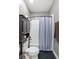 Cozy bathroom with white tiled shower/tub combination and dark cabinet for storage at 1029 Laurel Grove Cts, Suwanee, GA 30024