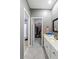 Bathroom with white vanity, framed mirror, and doorway leading to walk-in closet at 1029 Laurel Grove Cts, Suwanee, GA 30024