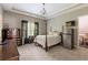 Bedroom with bed, trey ceiling, and dark wood furniture; also features mini-fridge at 1029 Laurel Grove Cts, Suwanee, GA 30024