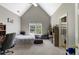 Bedroom featuring vaulted ceilings, a large window, and an ensuite bathroom at 1029 Laurel Grove Cts, Suwanee, GA 30024