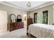 Bedroom with trey ceilings, nice natural light, and dark furniture with a view into ensuite at 1029 Laurel Grove Cts, Suwanee, GA 30024