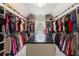 Large walk-in closet with custom shelving and center island at 1029 Laurel Grove Cts, Suwanee, GA 30024