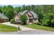 Charming home boasts a long driveway, lush lawn, and mature trees creating a serene setting at 1029 Laurel Grove Cts, Suwanee, GA 30024