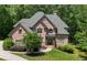 Stunning brick home features a well-manicured lawn with mature trees for added privacy at 1029 Laurel Grove Cts, Suwanee, GA 30024