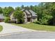 Charming two-story brick home with a well-manicured lawn and mature trees at 1029 Laurel Grove Cts, Suwanee, GA 30024