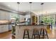 Bright kitchen with stainless appliances, center island with bar stools, and adjacent dining area at 1029 Laurel Grove Cts, Suwanee, GA 30024