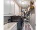 Functional laundry room featuring a sink, washer, dryer and ample shelving for organization at 1029 Laurel Grove Cts, Suwanee, GA 30024
