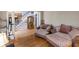 Comfortable living room featuring hardwood floors, two couches, and a staircase leading upstairs at 1029 Laurel Grove Cts, Suwanee, GA 30024