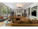 Comfortable living room featuring a fireplace, hardwood floors, and ample natural light at 1029 Laurel Grove Cts, Suwanee, GA 30024