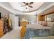 Relaxing main bedroom featuring a ceiling fan and a dresser with decorative mirror at 1029 Laurel Grove Cts, Suwanee, GA 30024