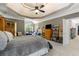 Spacious main bedroom with a tray ceiling, large windows, and a variety of furniture and decorations at 1029 Laurel Grove Cts, Suwanee, GA 30024