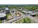 An aerial view features a vibrant downtown area with commercial buildings and mature trees at 110 Barnesdale Ter, Woodstock, GA 30188