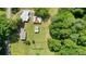A high-angle aerial shot of the home with approximate boundary, surrounded by lush trees at 110 Barnesdale Ter, Woodstock, GA 30188