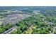An aerial view displays the property's location amid lush greenery and a quiet neighborhood at 110 Barnesdale Ter, Woodstock, GA 30188