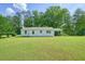 Large backyard showcasing the lawn, a covered carport, and additional space at 110 Barnesdale Ter, Woodstock, GA 30188