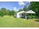 Side view showing the property, with a carport and lush lawn at 110 Barnesdale Ter, Woodstock, GA 30188