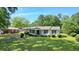 Charming single-story home featuring a well-manicured lawn, dark shutters, and covered front porch at 110 Barnesdale Ter, Woodstock, GA 30188